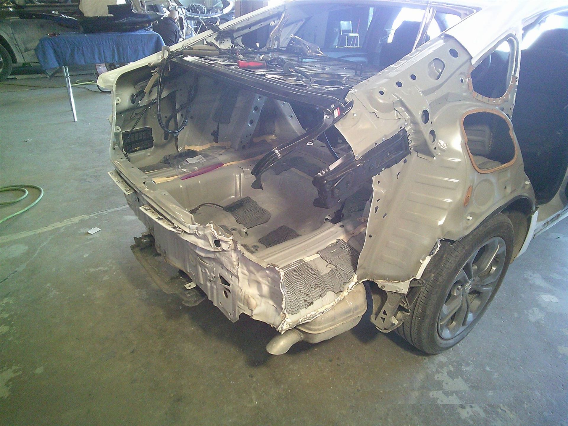 A car is being dismantled in a garage