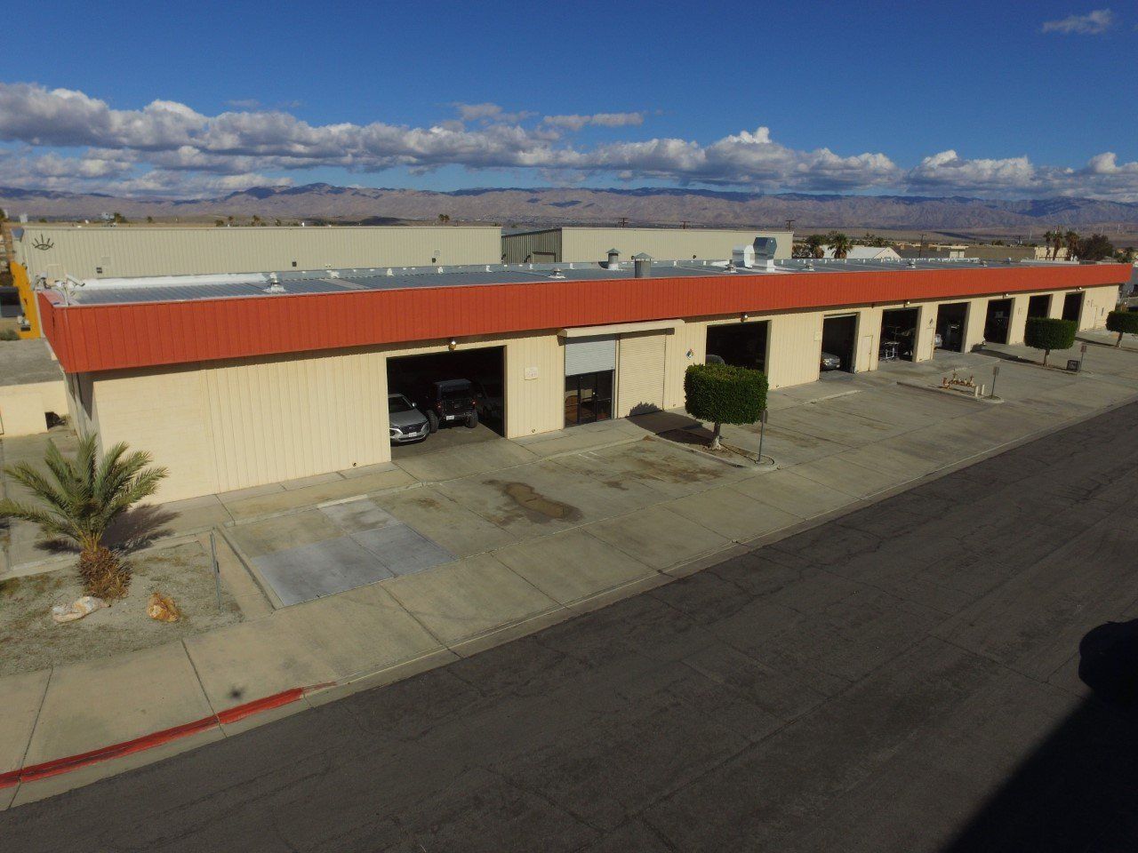 An aerial view of a building with a red roof