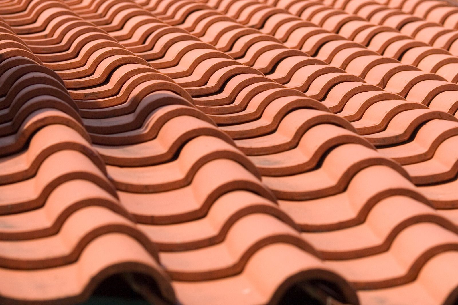 Close-up of terracotta roof tiles in a repeating wave pattern