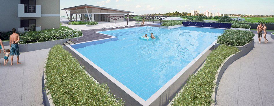 A group of people are swimming in a large swimming pool.