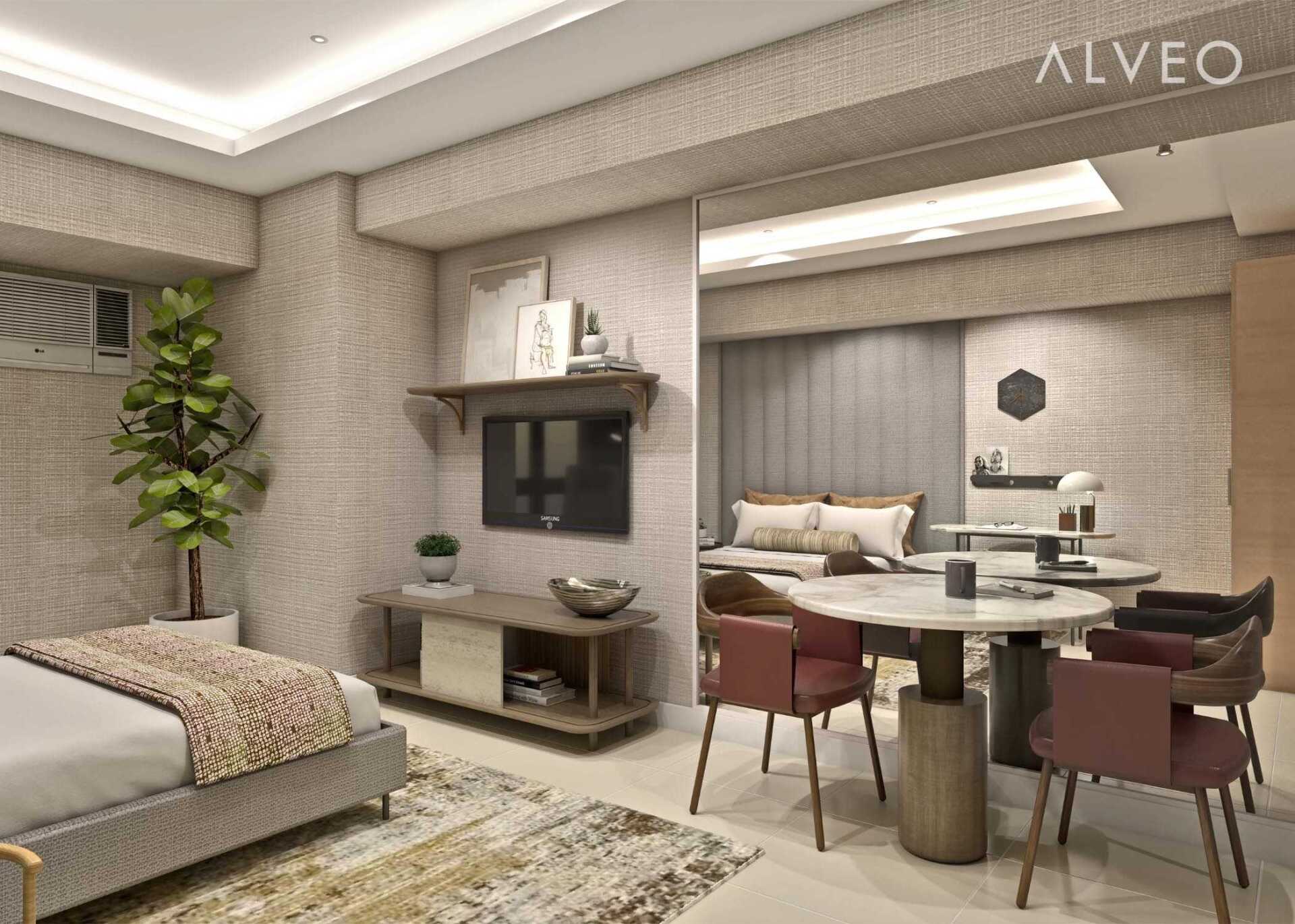 A bedroom with a bed , dining table , chairs and a television.