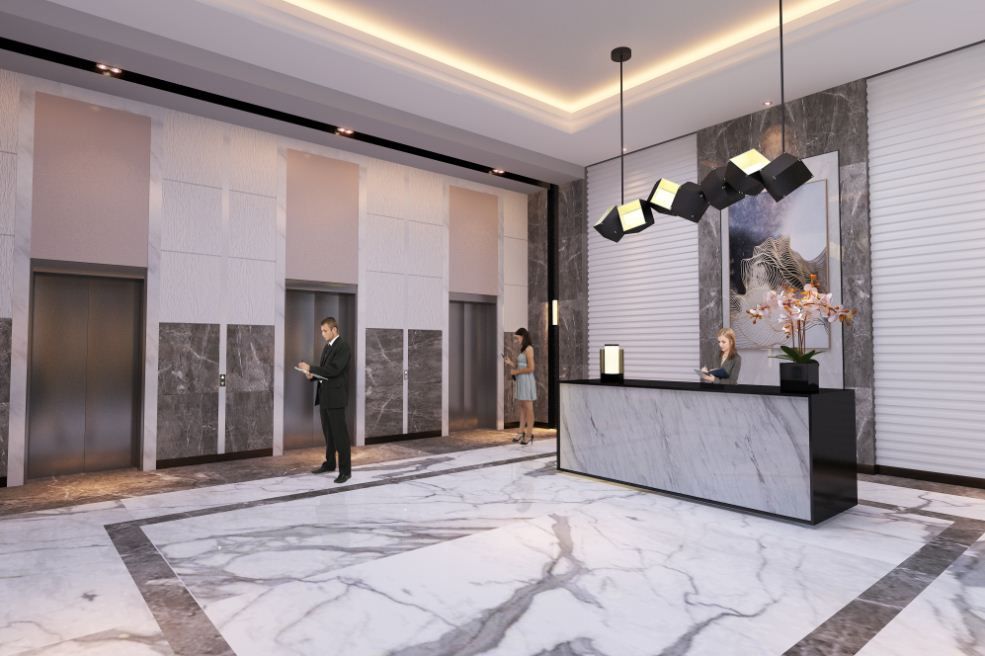 A man in a suit is standing in a lobby next to a marble counter.