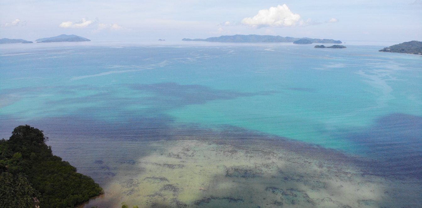 An aerial view of a large body of water with islands in the distance.