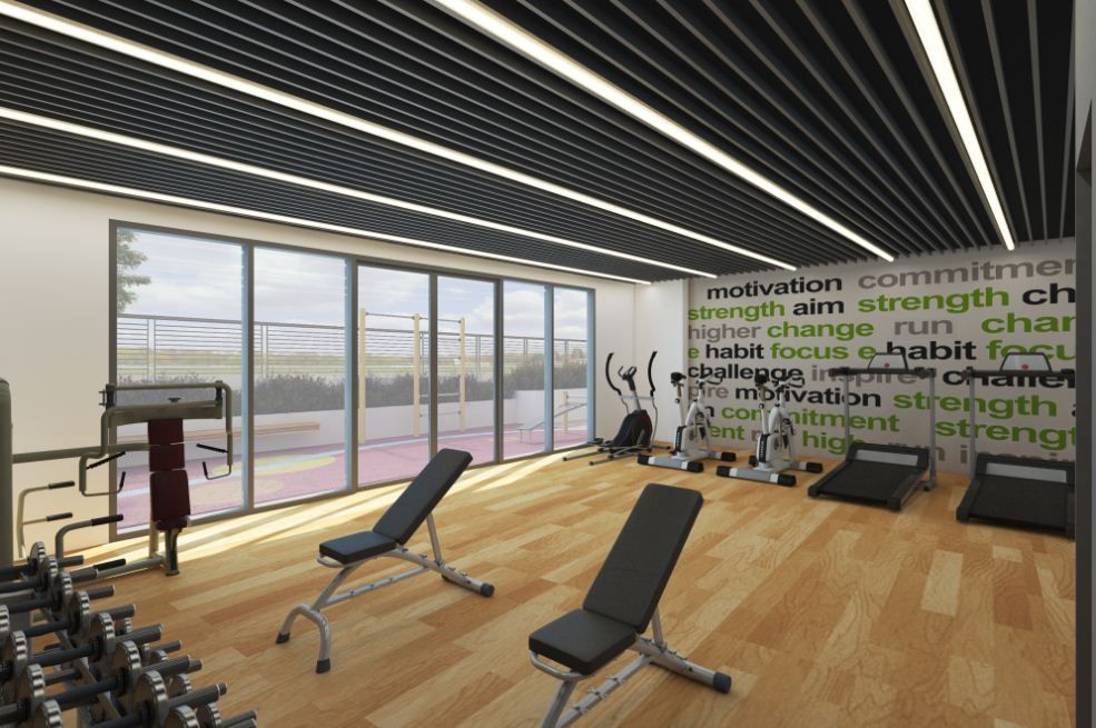 A gym with a lot of equipment and a large window.