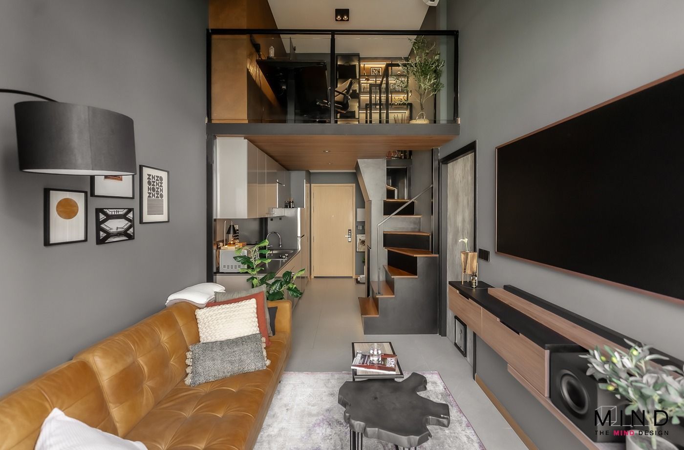 A living room with a brown couch and a flat screen tv, loft builted in for condo