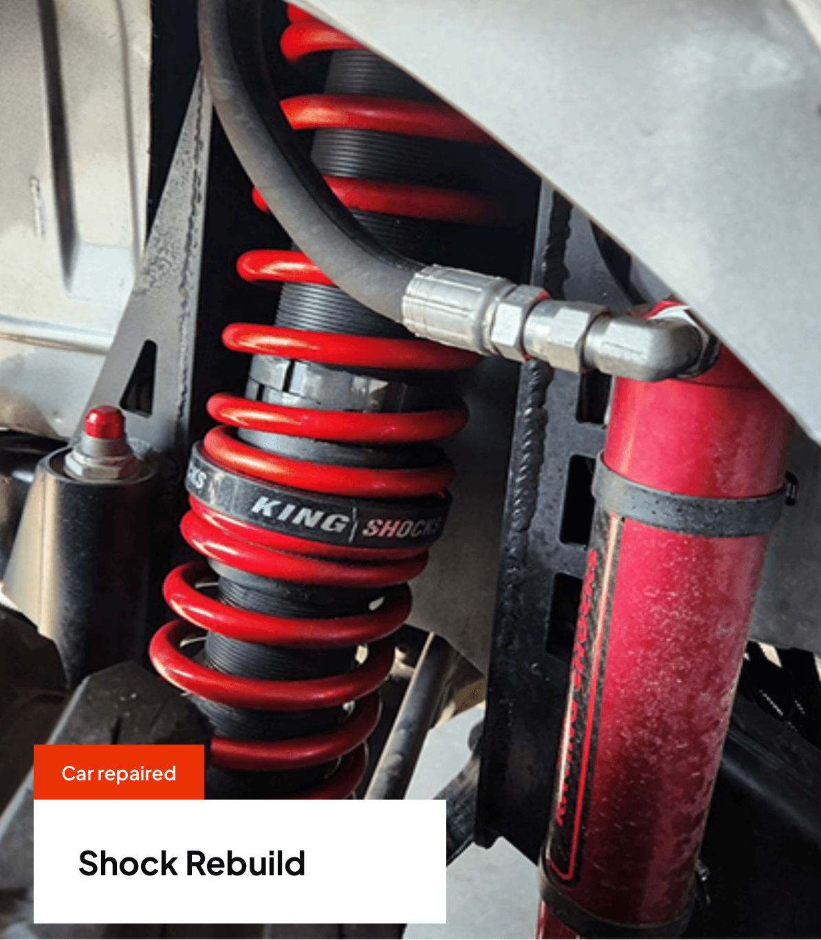 Red King Shock absorber being rebuilt on a vehicle.
