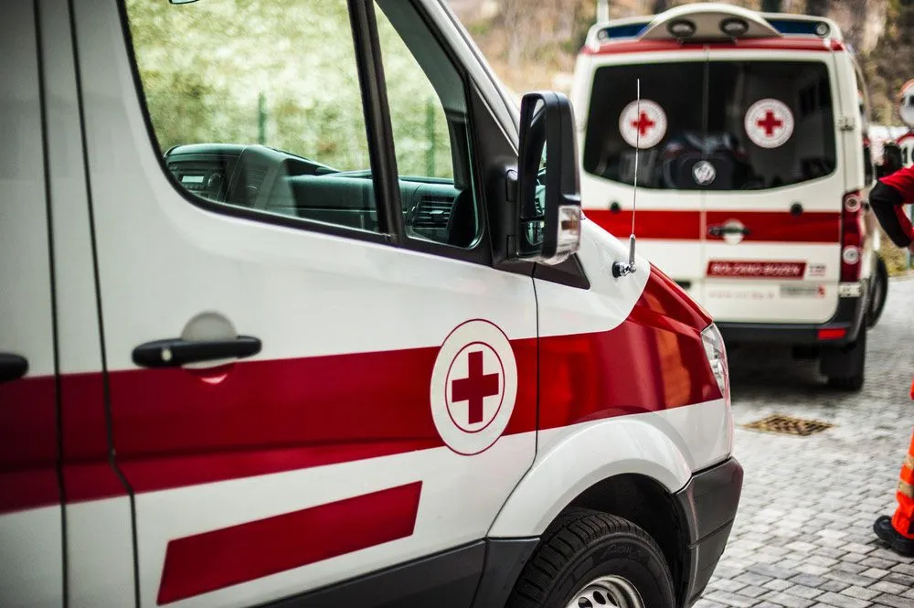 Two Ambulances Are Parked Next to Each Other on a Cobblestone Street — Truck Training and Assessments In Umina Beach, NSW