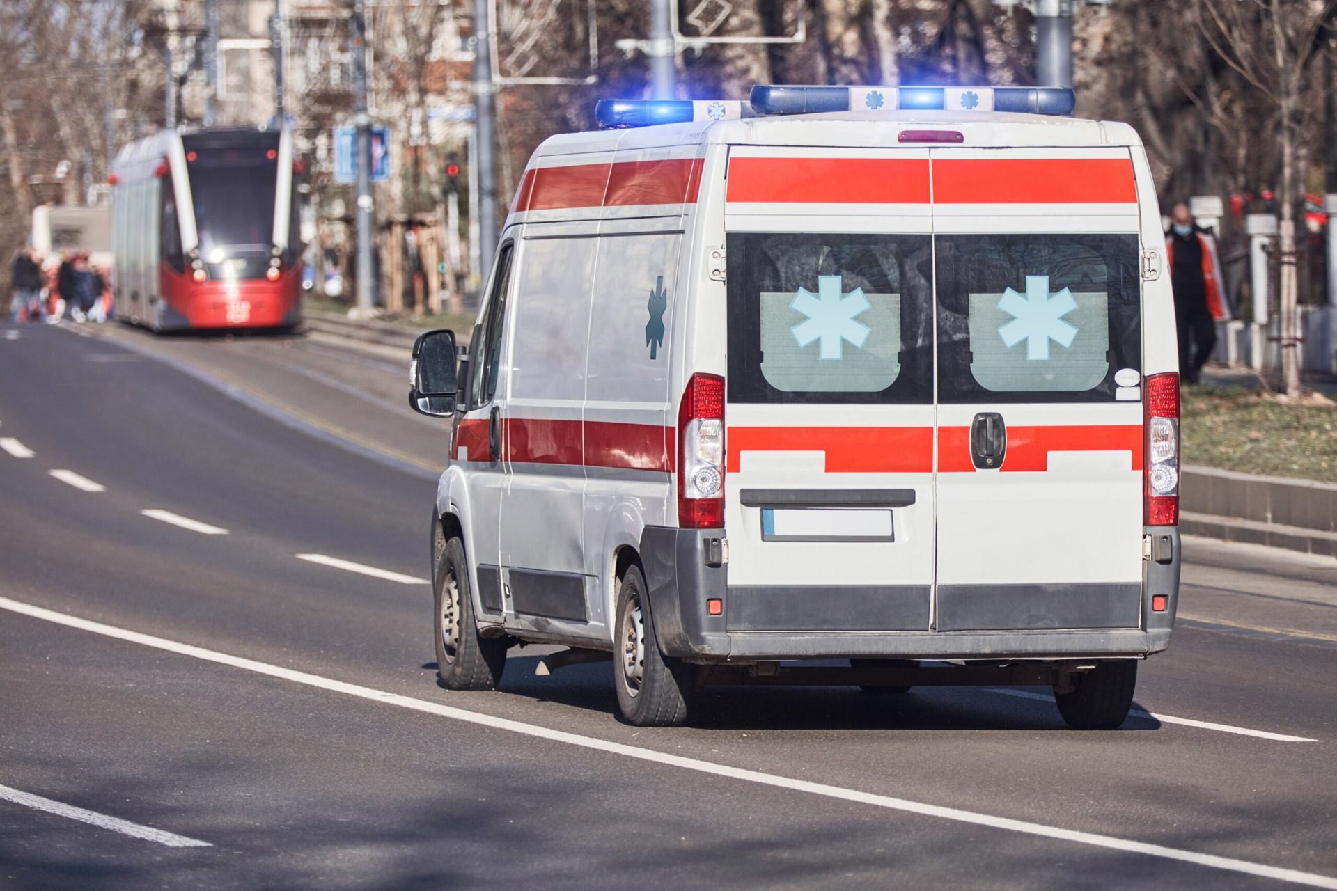 An Ambulance is Driving Down a City Street — Truck Training and Assessments In Umina Beach, NSW