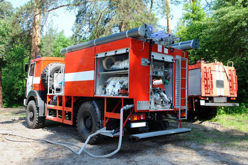 Two Fire Trucks Are Parked Next to Each Other in the Woods — Truck Training and Assessments In Umina Beach, NSW