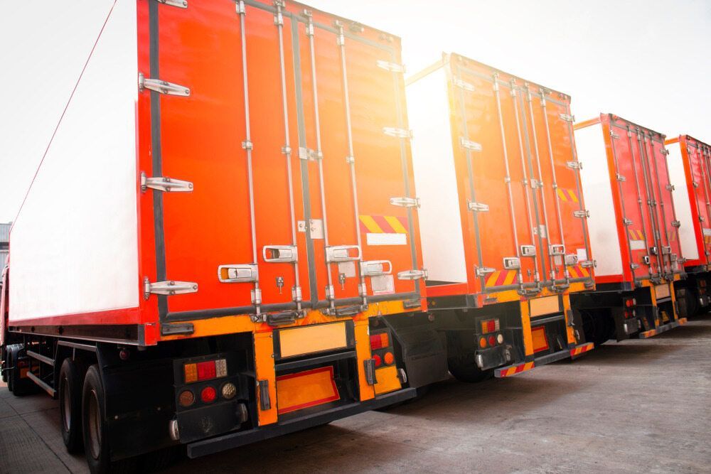 A Row of Red Semi Trucks Parked Next to Each Other in a Parking Lot — Truck Training and Assessments In Umina Beach, NSW
