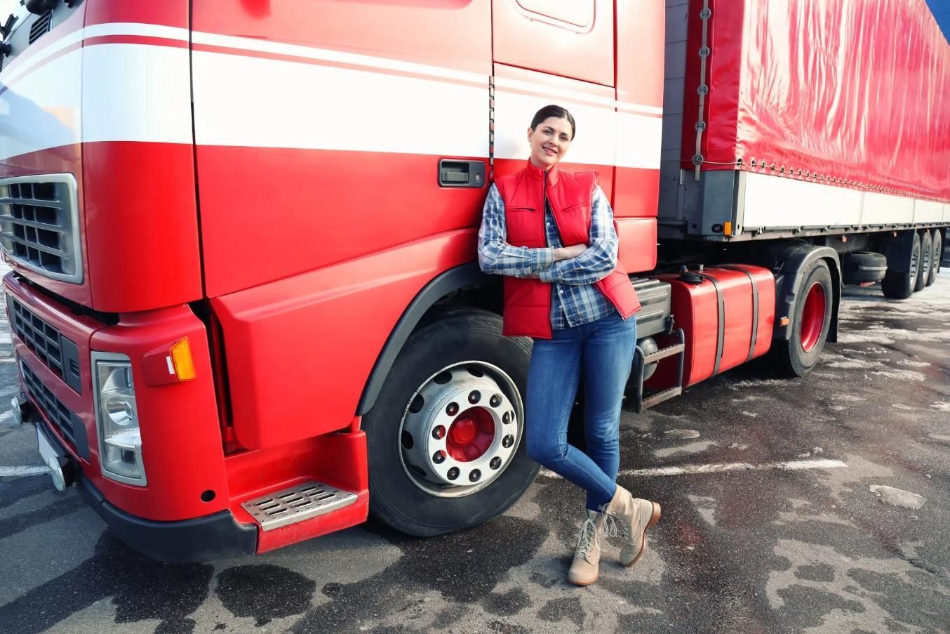A Woman is Leaning Against a Red Semi Truck in a Parking Lot — Truck Training and Assessments In Umina Beach, NSW