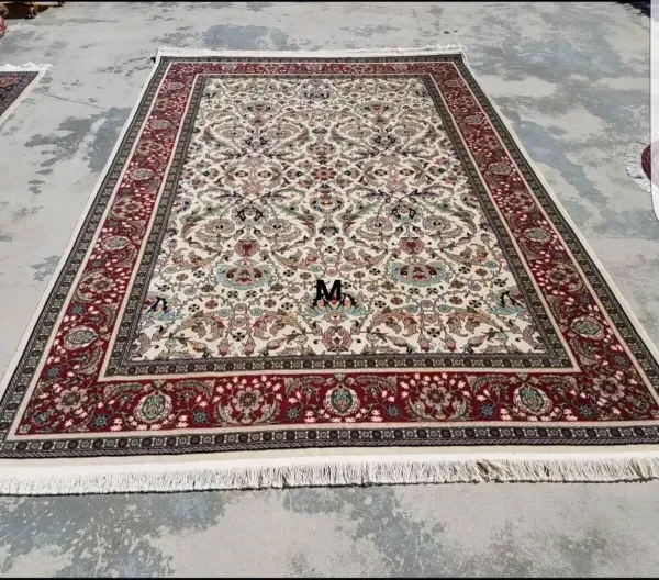 A large rug is sitting on top of a concrete floor.