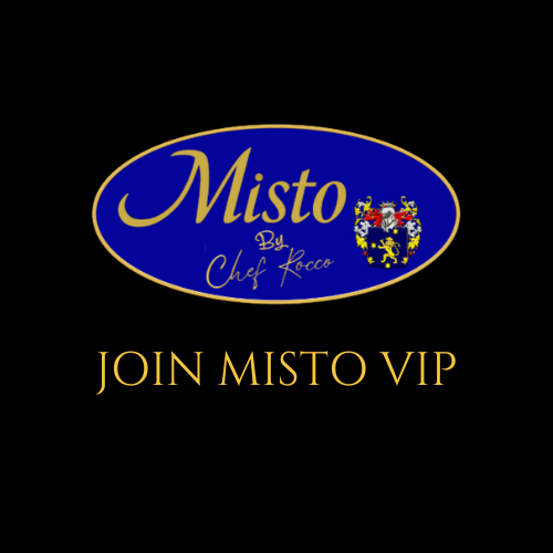 A man is standing with his arms crossed in front of a sign that says join now become a vip