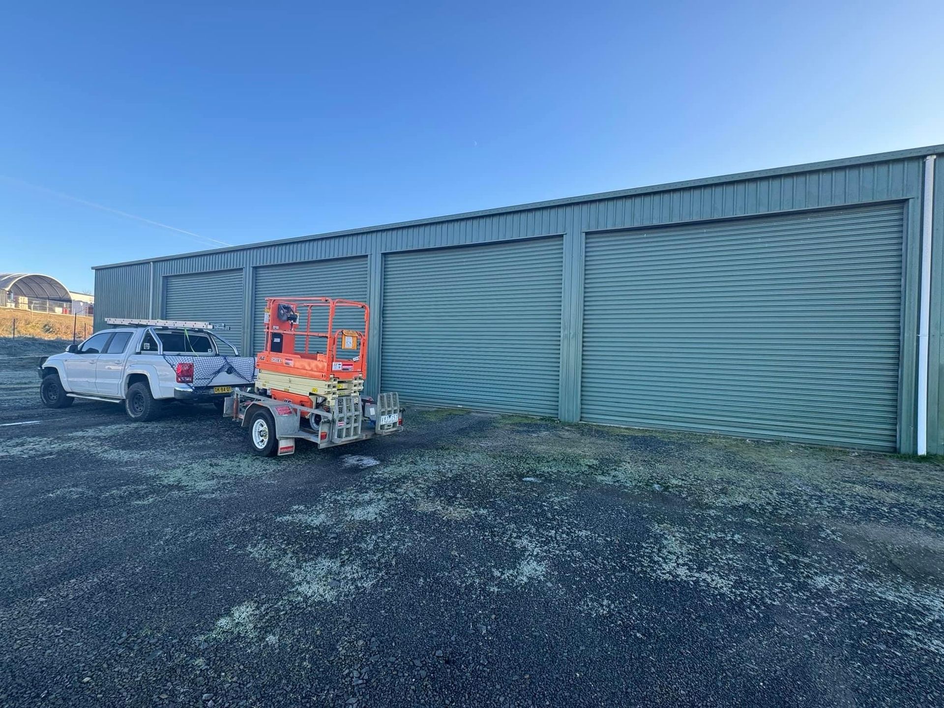 A man is installing a garage door with a drill.