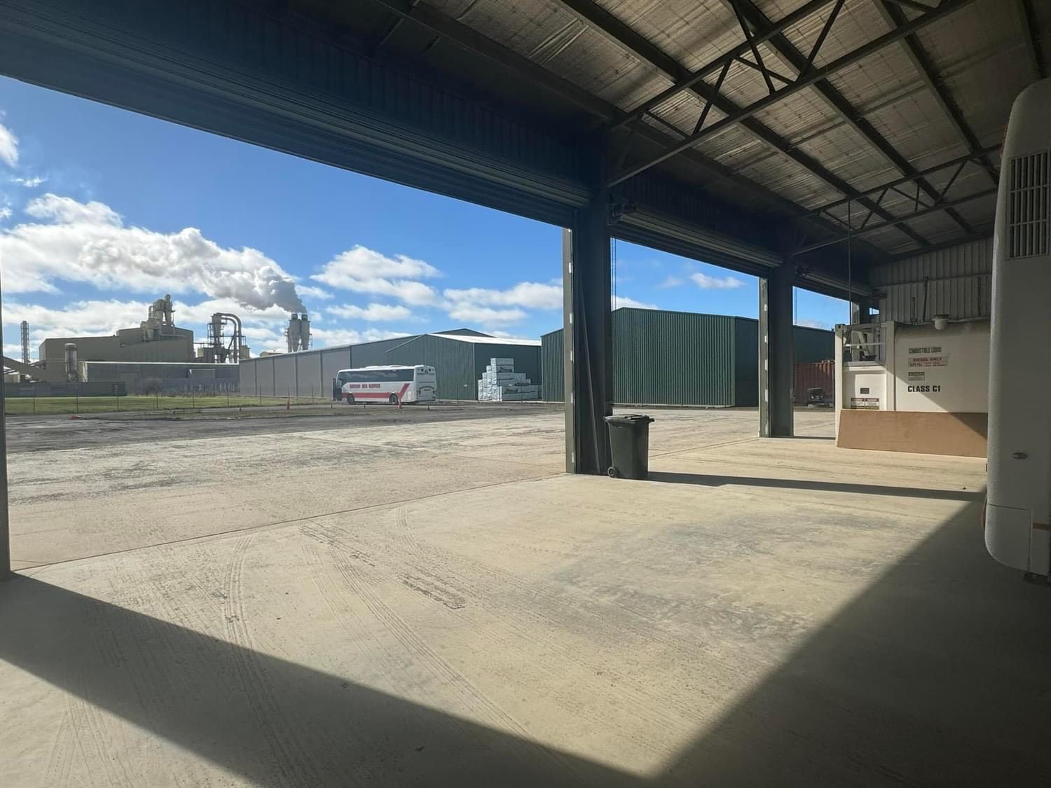 A man is opening a garage door with his hand.