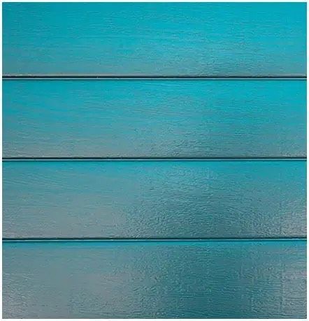 A close up of a blue wooden wall with a gradient of blue.