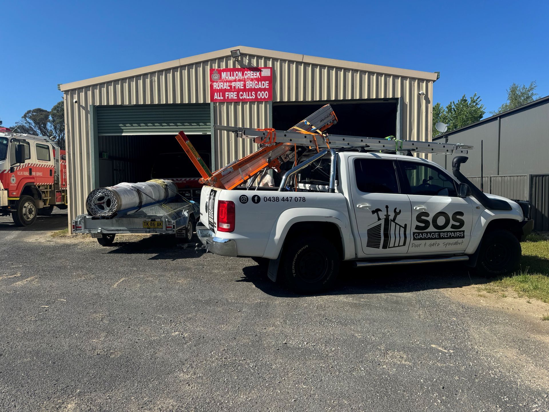 A sos truck is parked in front of a building.