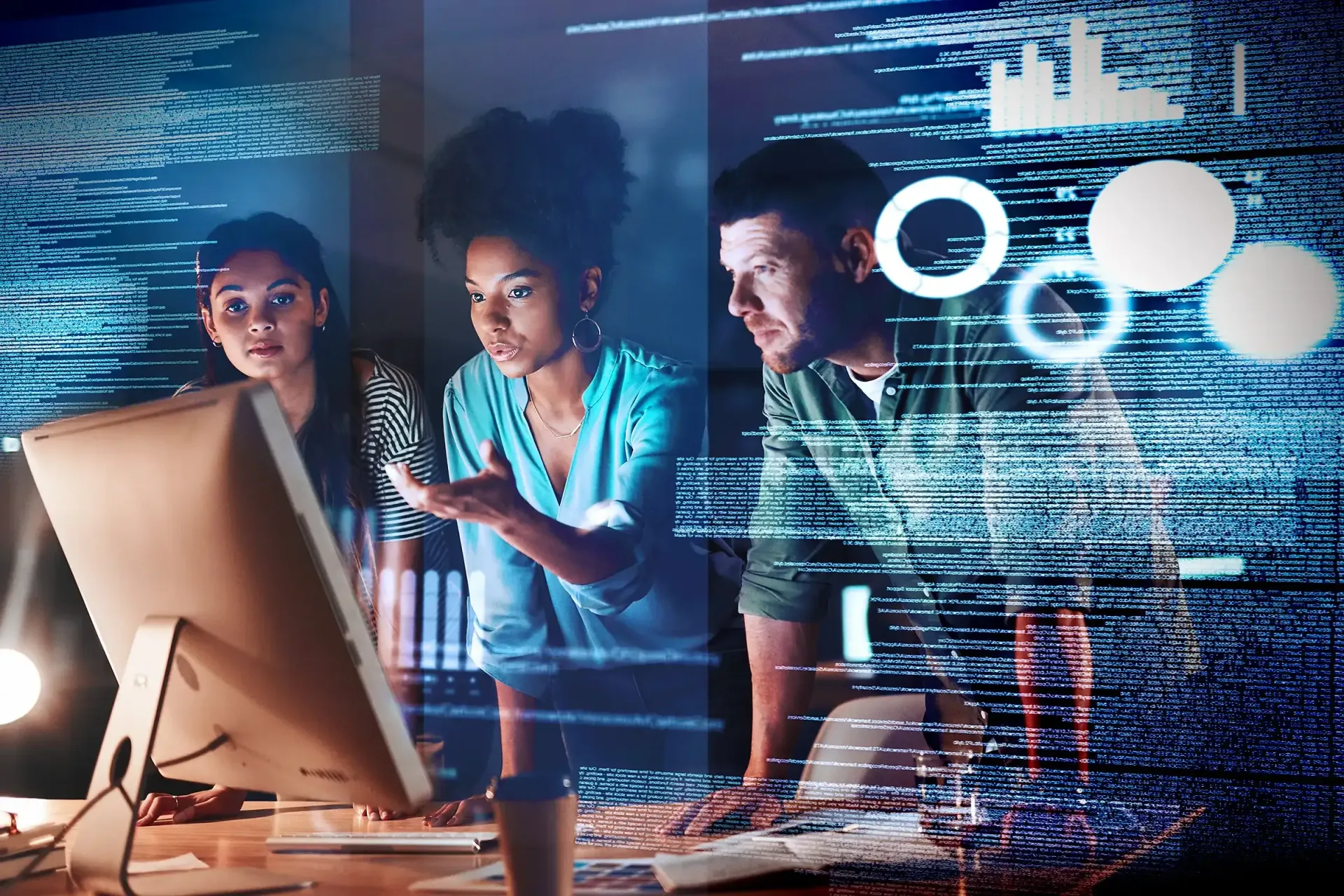 Three people looking at a computer screen, surrounded by glowing code.
