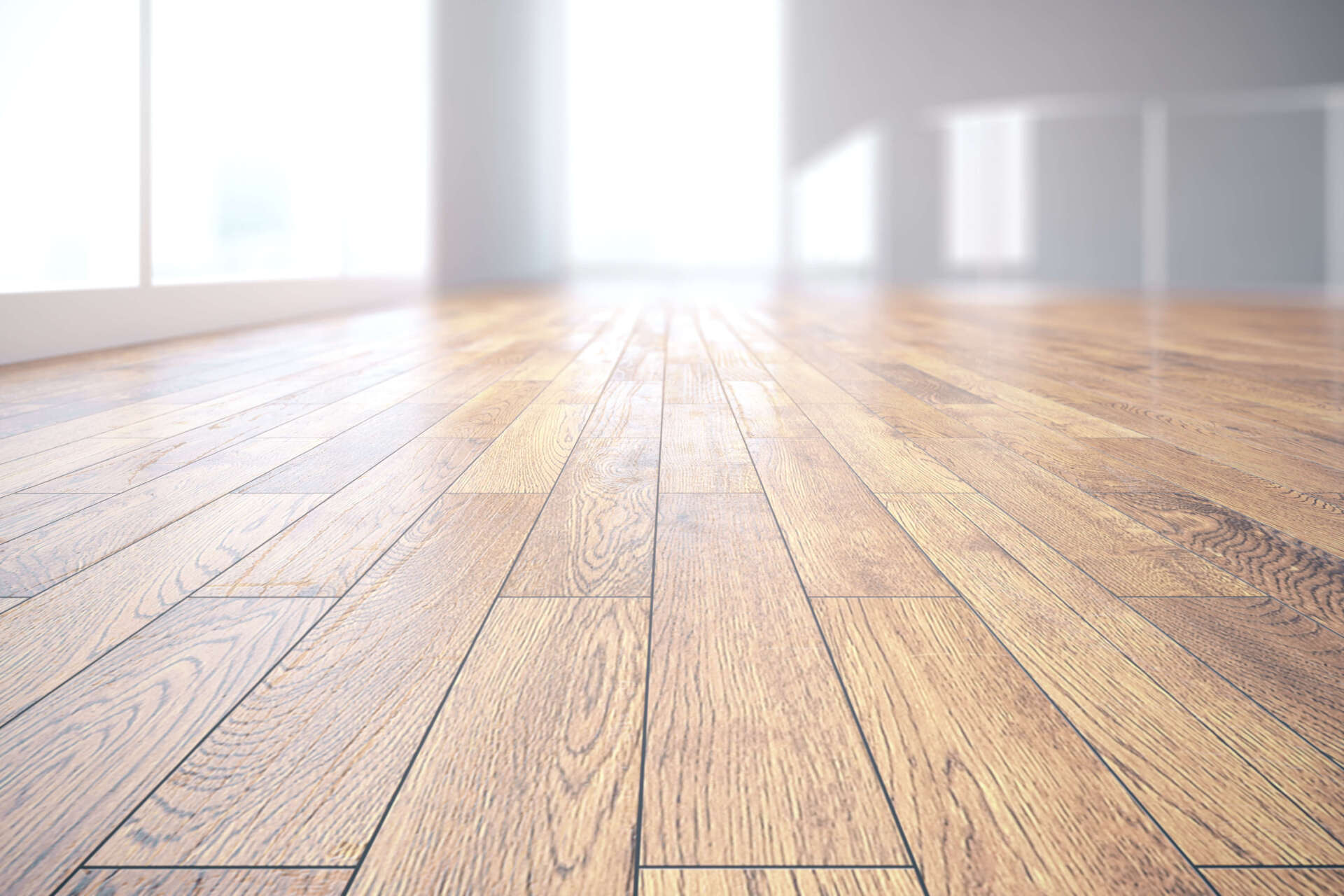 Empty sunlit wooden floor in a bright, modern room