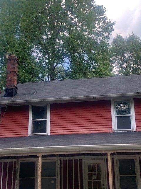 Red house with dark roof and chimney in northfield, nj