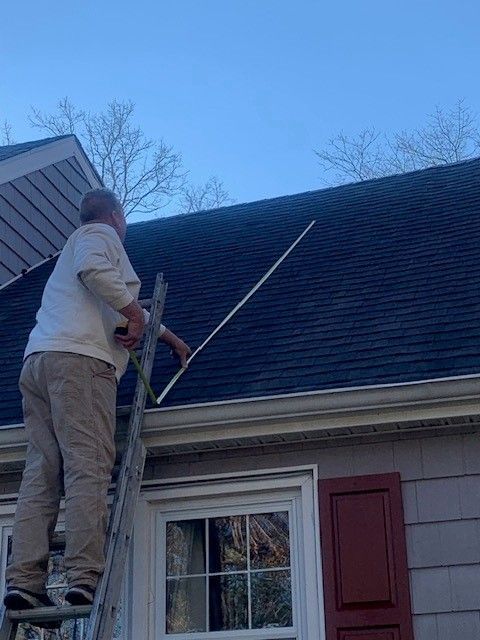 Affordable Roofing Services employee measuring a roof with tape in atlantic county, new jersey