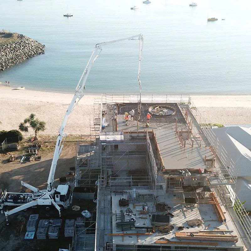 An Aerial View of a Building Under Construction Near the Ocean — Polley's Concrete Pumping in Moranbah, QLD
