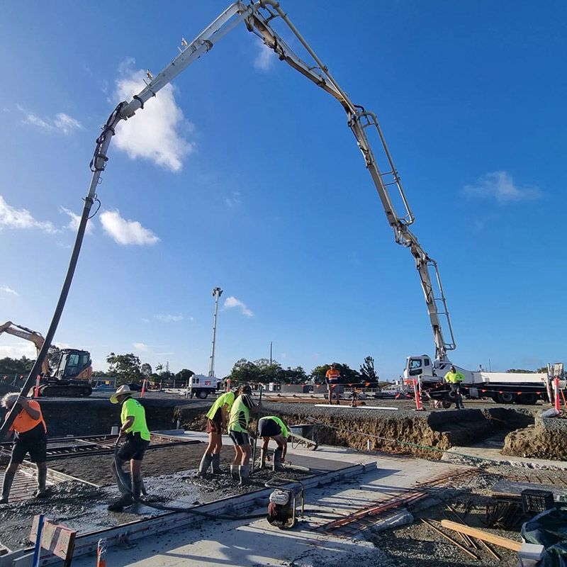 A Group of Construction Workers Are Working on a Construction Site — Polley's Concrete Pumping in Airlie Beach, QLD