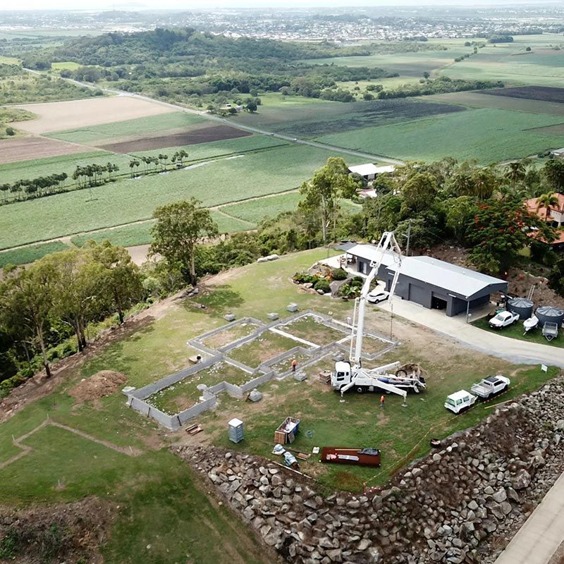 An Aerial View of a Construction Site With a Crane in the Middle of the Field — Polley's Concrete Pumping in Airlie Beach, QLD