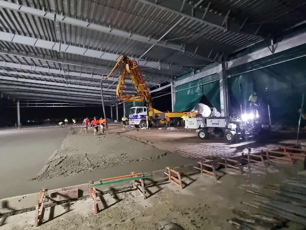A Concrete Pump is Being Used to Pour Concrete Into a Large Building — Polley's Concrete Pumping in Kuttabul, QLD