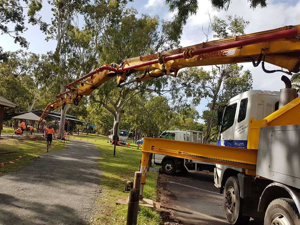 A Concrete Pump Truck is Parked on the Side of the Road in a Park — Polley's Concrete Pumping in Kuttabul, QLD
