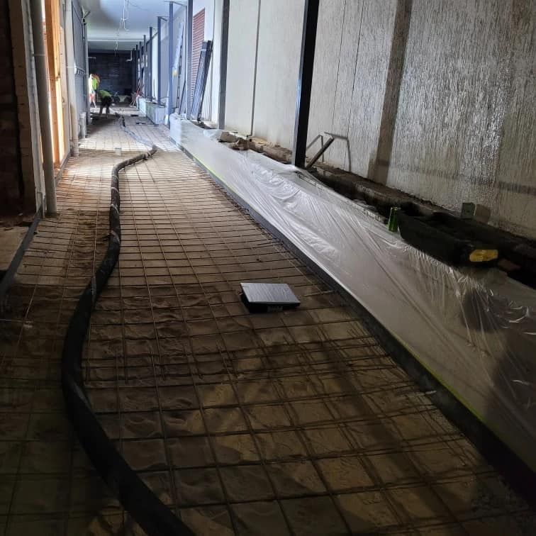 A Long Hallway With a Hose in the Middle of It — Polley's Concrete Pumping in Kuttabul, QLD