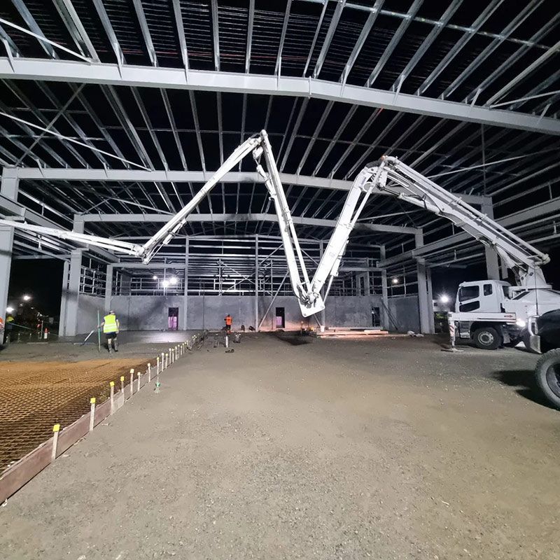 A Concrete Pump is Pouring Concrete Into a Building — Polley's Concrete Pumping in Kuttabul, QLD