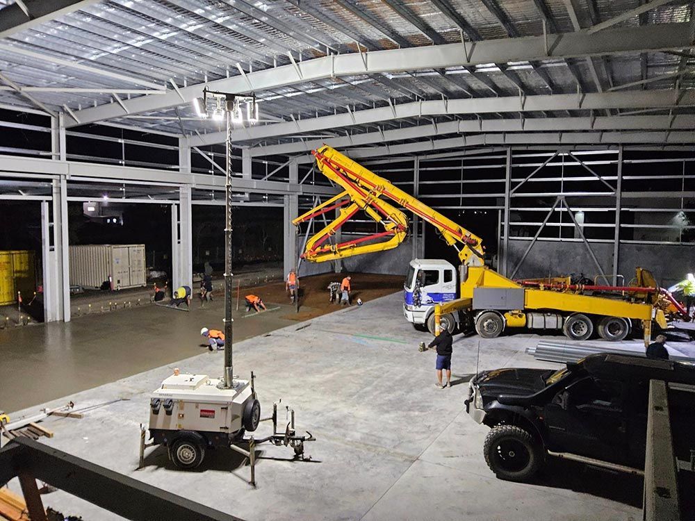 A Concrete Pump is Being Used to Pour Concrete Into a Large Building — Polley's Concrete Pumping in Kuttabul, QLD