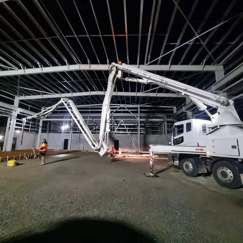 A White Truck With a Concrete Pump Attached to It — Polley's Concrete Pumping in Kuttabul, QLD
