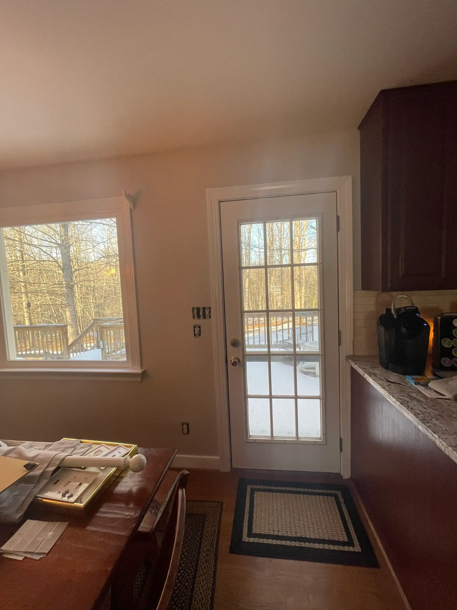 A kitchen with a french door and a window.