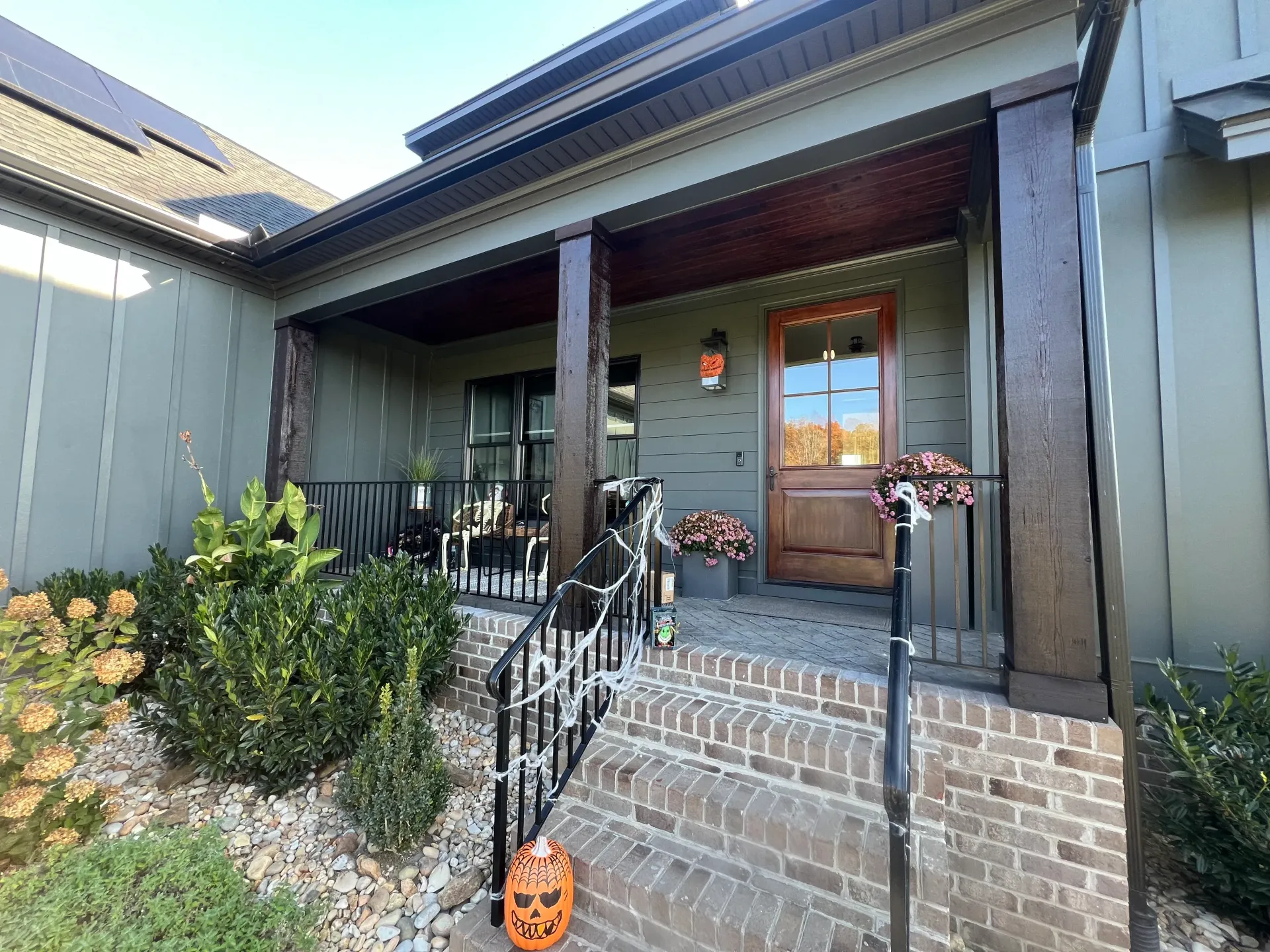 A house with a porch and stairs decorated for halloween.