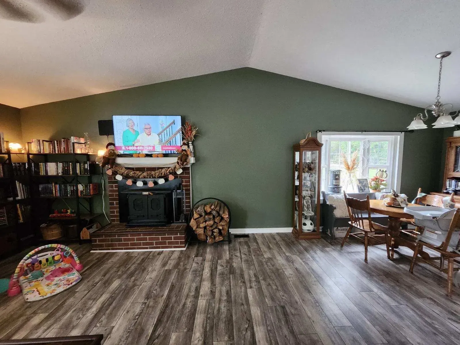 A living room with a fireplace and a flat screen tv.