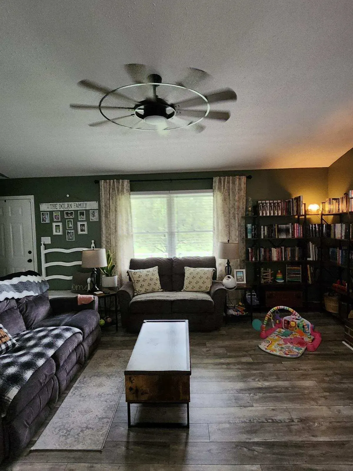 A living room filled with furniture and a ceiling fan.