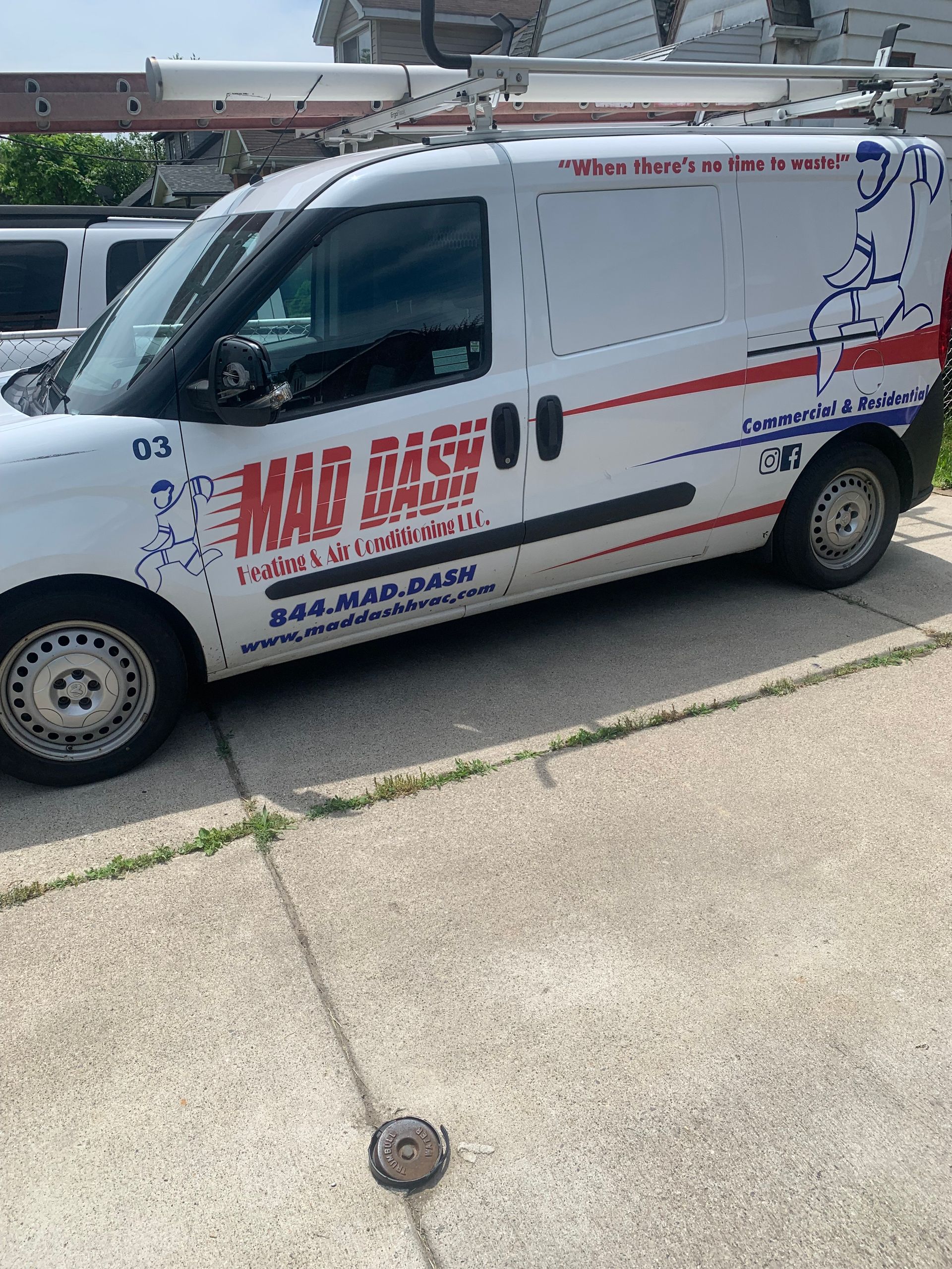 A woman is sitting on a couch holding a remote control.