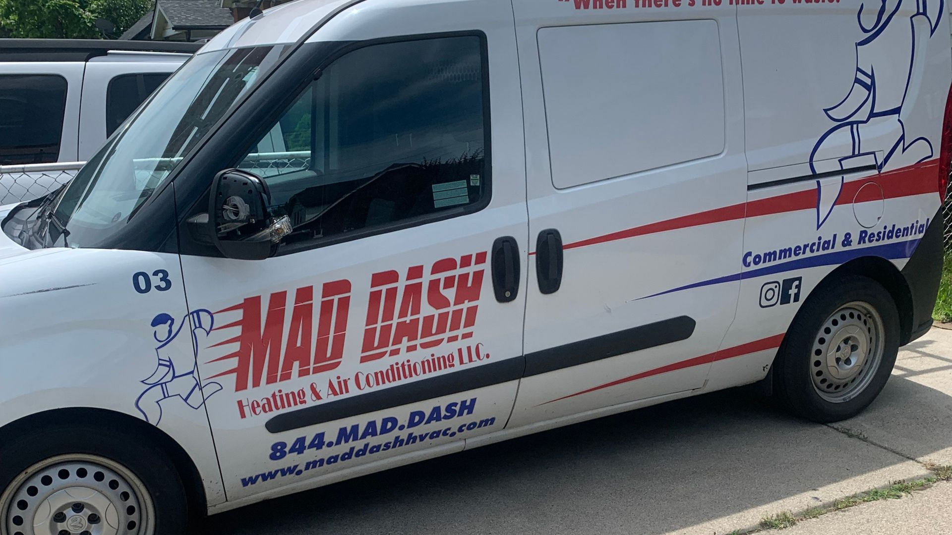 White Mad Dash service van with company logo parked outdoors.