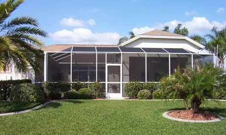 Large house with brown roof and pool enclosure  — Leesburg, FL — Aluminum Contractors Inc