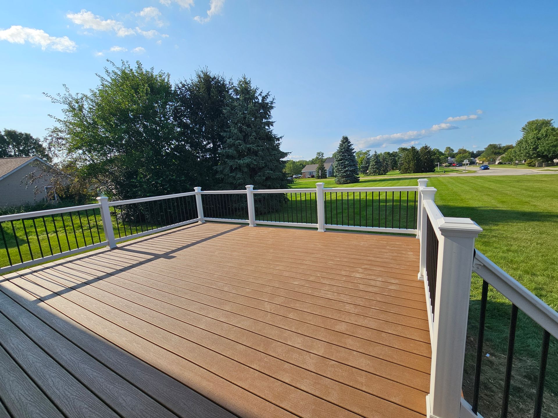 A stone house with a wooden deck in front of it