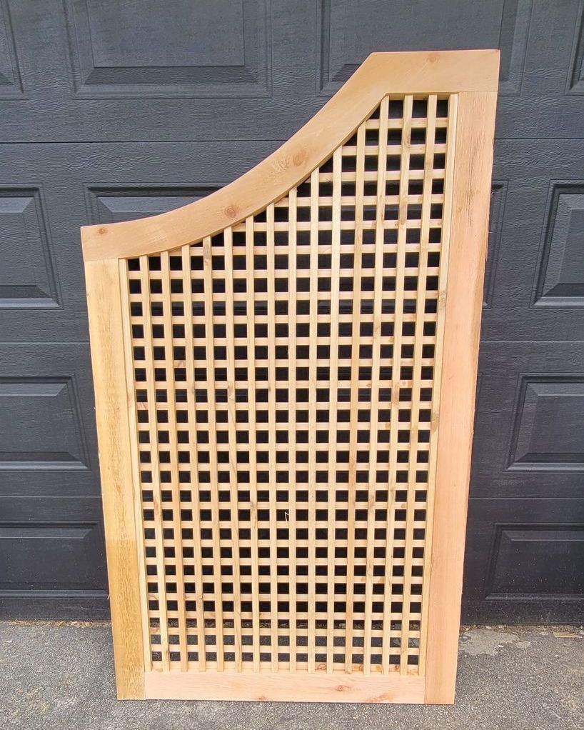 A wooden lattice is sitting in front of a black door