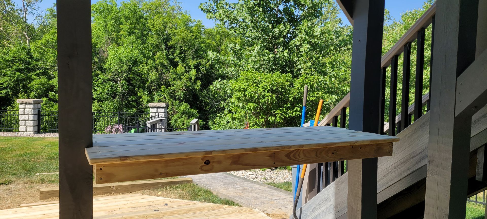 A wooden table is sitting on top of a wooden deck .
