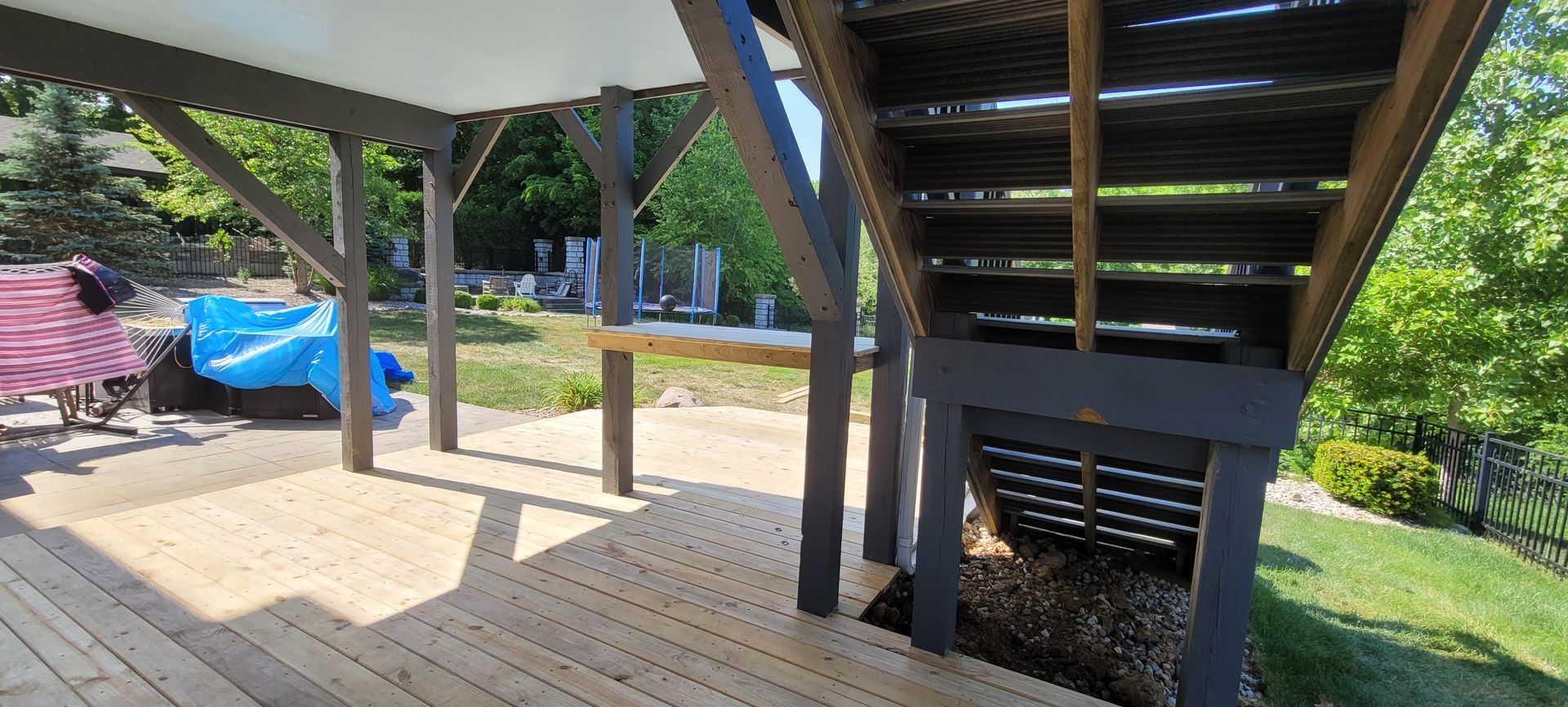 A wooden deck with stairs leading up to it .