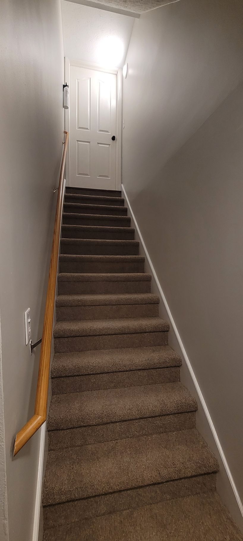 A set of stairs leading up to a door in a house .