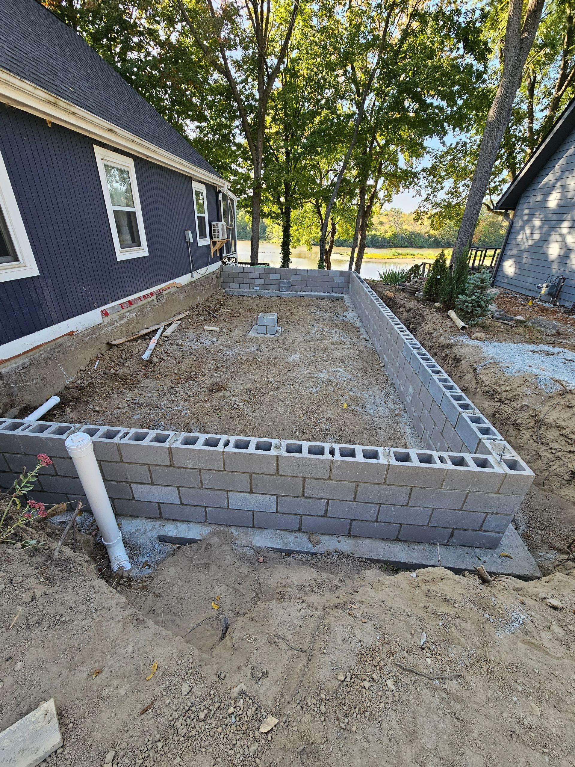 A brick wall is being built in front of a house .