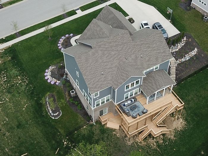 An aerial view of a house with a large deck