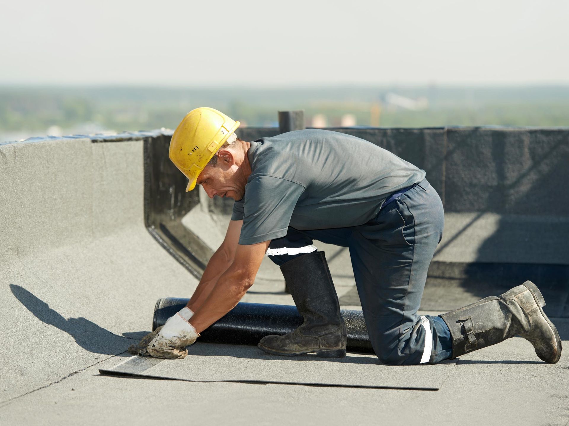 Man Repairing Flat Roof — Hubertus, WI — Northwest Roofing, Inc.