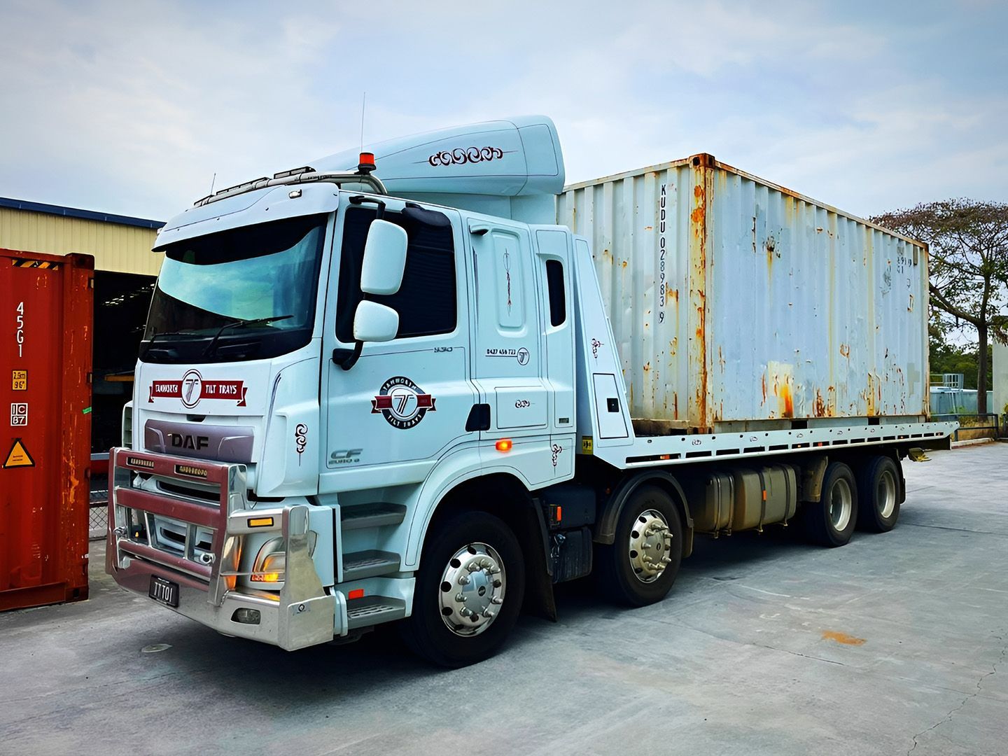 Rusty Shipping Container Loaded On Flatbed Truck For Transport